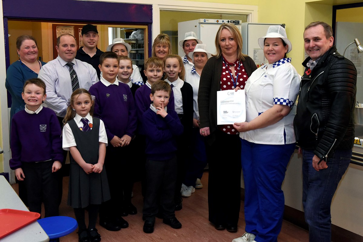 Cllr McMahon presents an Eat Safe Award to Loanhead Primary Catering team