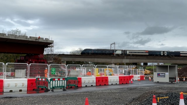 Avanti West Coast train on existing Clifton bridge with new steel structure on the right: Avanti West Coast train on existing Clifton bridge with new steel structure on the right