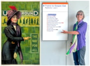 TfL Image - Helen Pankhurst next to a London Overground Suffragette line route map and an Underground poster designed by Alfred France in 1911: TfL Image - Helen Pankhurst next to a London Overground Suffragette line route map and an Underground poster designed by Alfred France in 1911