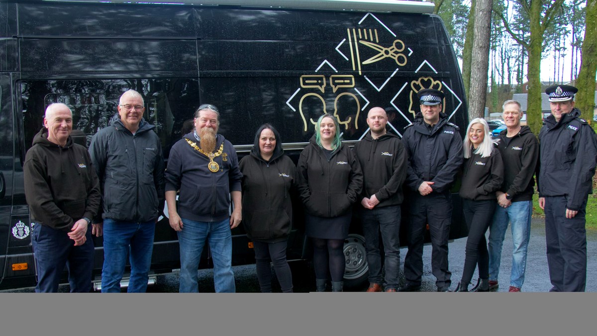Local partners, including Provost of East Ayrshire, gather in front of mobile hairdressing vehicle to launch new community hairdressing initiative.