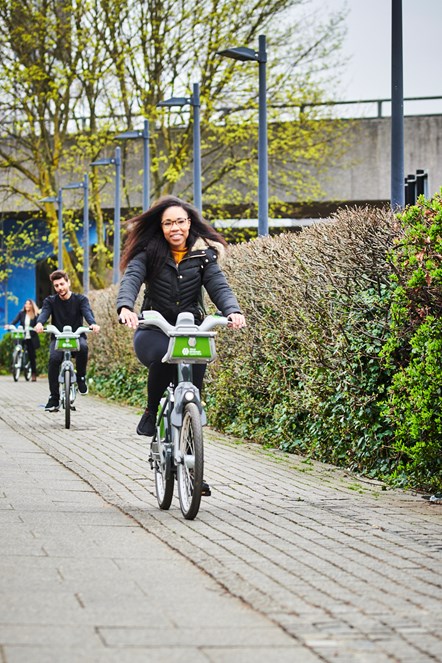 Woman riding hire cycle