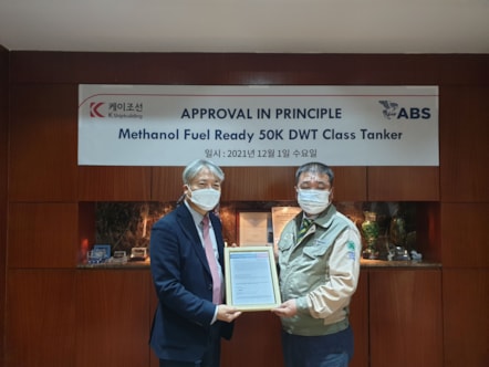 Seong Hun Kim, ABS  Director, Korea Business Development presents the AIP to Tae-Hyun Koh, K Shipbuilding Chief Technology Officer.
