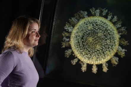 Injecting Hope Curator Sophie Goggins with 2020: The Sphere that Changed the World by Angela Palmer. The artwork is on display in Injecting Hope, a new exhibition at the National Museum of Scotland.

Photo ©  Stewart Attwood