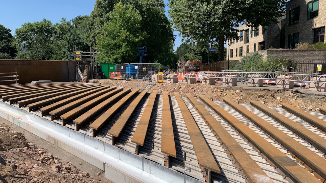 Looking west along Downs Park Road, with the infill beams in place and specialist material added to fill the gaps between the beams