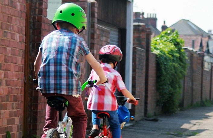 Young boys riding bikes to school: School Streets providing safer travel to school