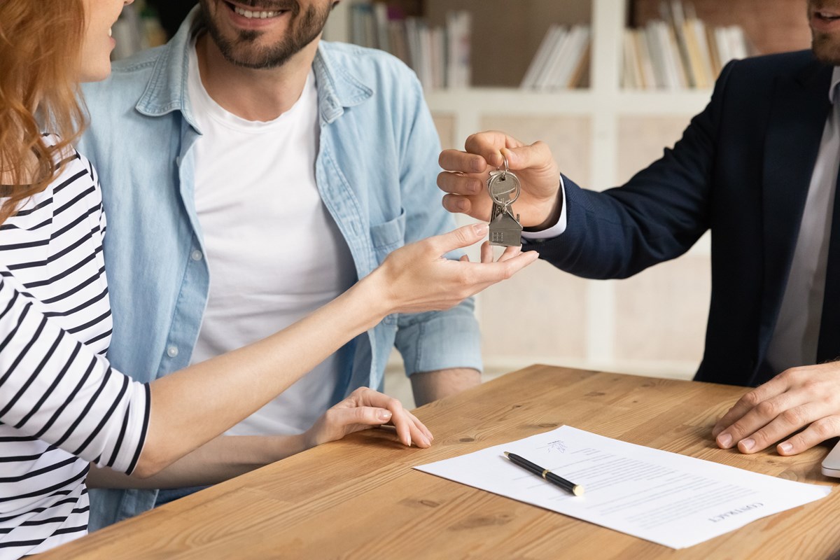 couple receiving key to a property