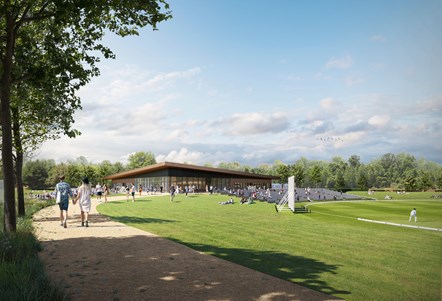 A view of the outside of the proposed cricket pavilion, with one of the pitches on the right hand side and spectators watching the match.