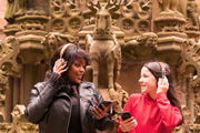 Linlithgow Scots Audio Guide: Laura Lovemore, a professional Scottish actor who provides the voice of Margaret More, one of the women known in the records as the ‘Moorish Lassies’, listening to the new Scots audio guide at Linlithgow Palace with Martha who voices the young Princess Elizabeth, daughter of James VI & Anna of Denma