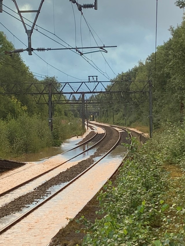 Tracks inundated with water after main bursts in Audenshaw