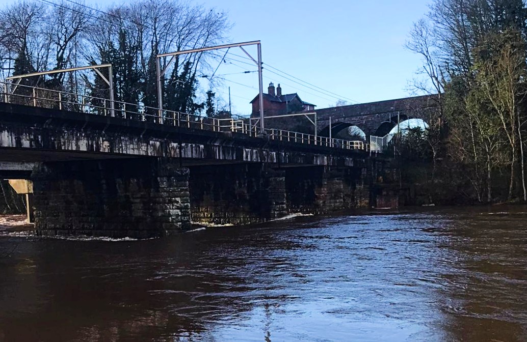 High water levels on the River Eden by West Coast Main line viaducts in Carlisle December 2022
