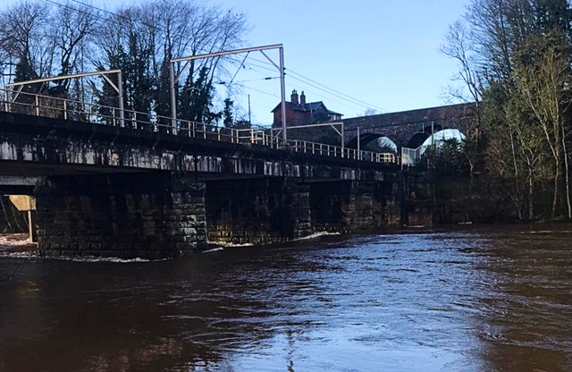 High water levels on the River Eden by West Coast Main line viaducts in Carlisle December 2022