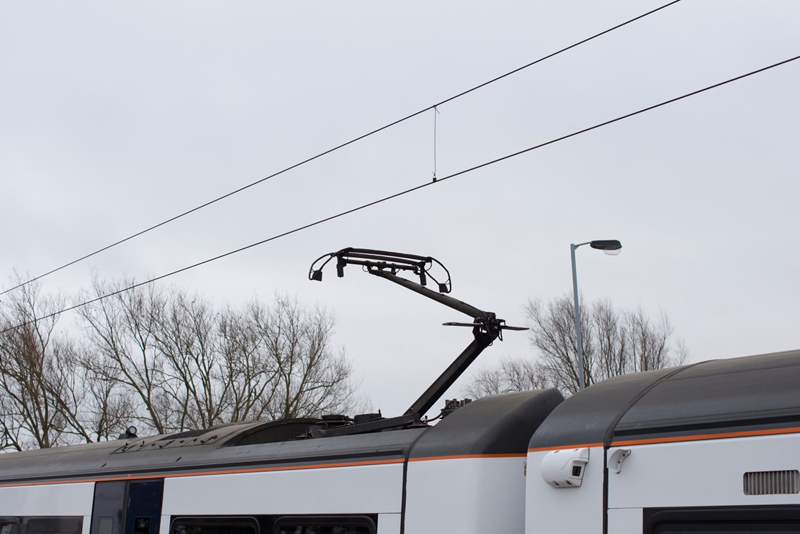 Pantograph on battery-powered train (IPEMU) descending: The new train contributes to Network Rail’s commitment to reduce its environmental impact, improve sustainability and reduce the cost of running the railway by 20 per cent over the next five years. It could ultimately lead to a fleet of battery-powered trains running on Britain’s rail network which are quieter and more efficient than diesel-powered trains, making them better for passengers and the environment. Network Rail and its industry partners – including Bombardier, Abellio Greater Anglia, FutureRailway and the Rail Executive arm of the Department for Transport (which is co-funding the project) – recognise the potential for battery-powered trains to bridge gaps between electrified parts of the network and to run on branch lines where it would be too expensive to install overhead electrification.