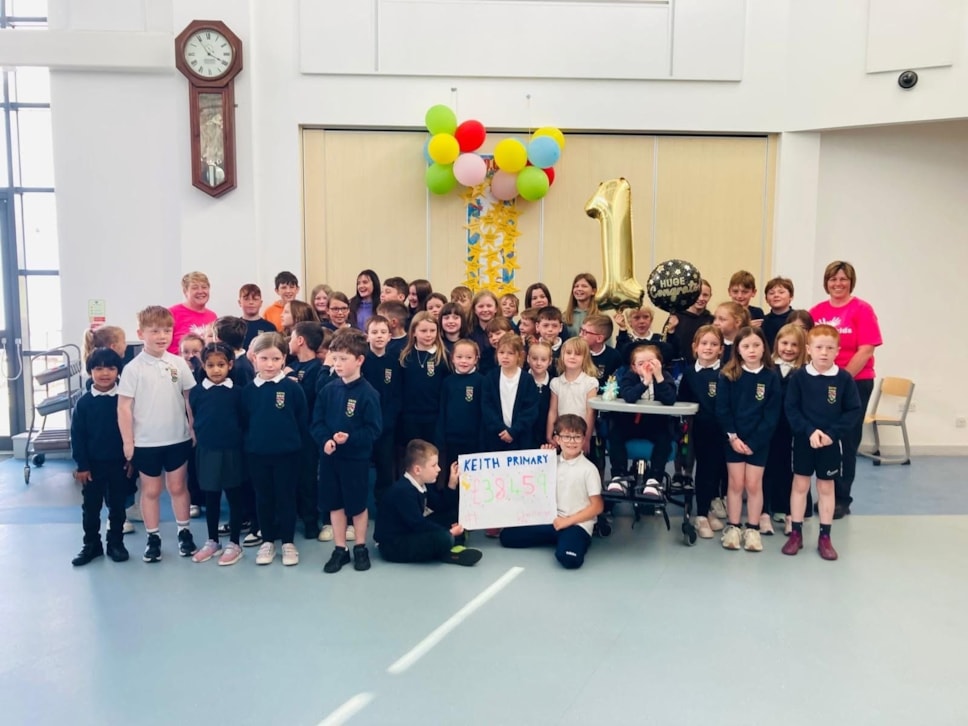 A group of Keith Primary School pupils are pictured joyfully receiving their prize money after winning the MFR Cash for Kids Challenge.