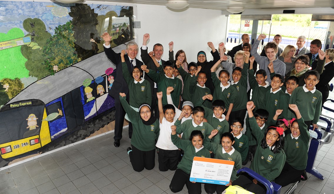 Rt Hon Jack Straw MP at Blackburn station: Jack Straw MP and pupils from Daisyfield Primary School punch the air in celebration of their artwork being unvelied on Blackburn station. (24 June 2011)