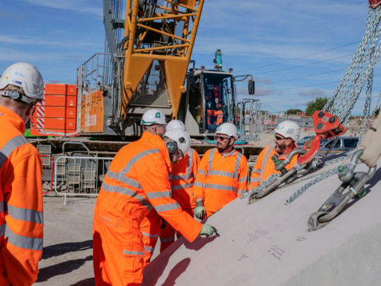 The team building the Wendover green tunnel add their signatures to the final segment October 2026
