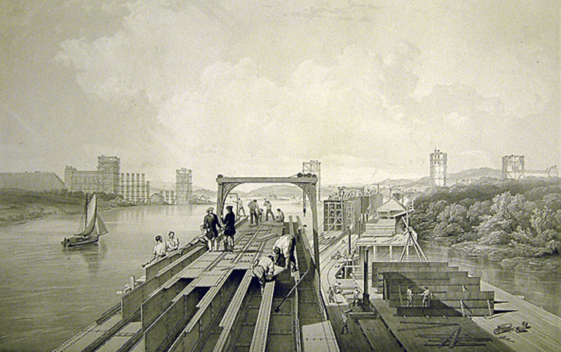 Britannia Bridge over taken during its construction in 1848 showing partially completed piers in background - credit NRM York