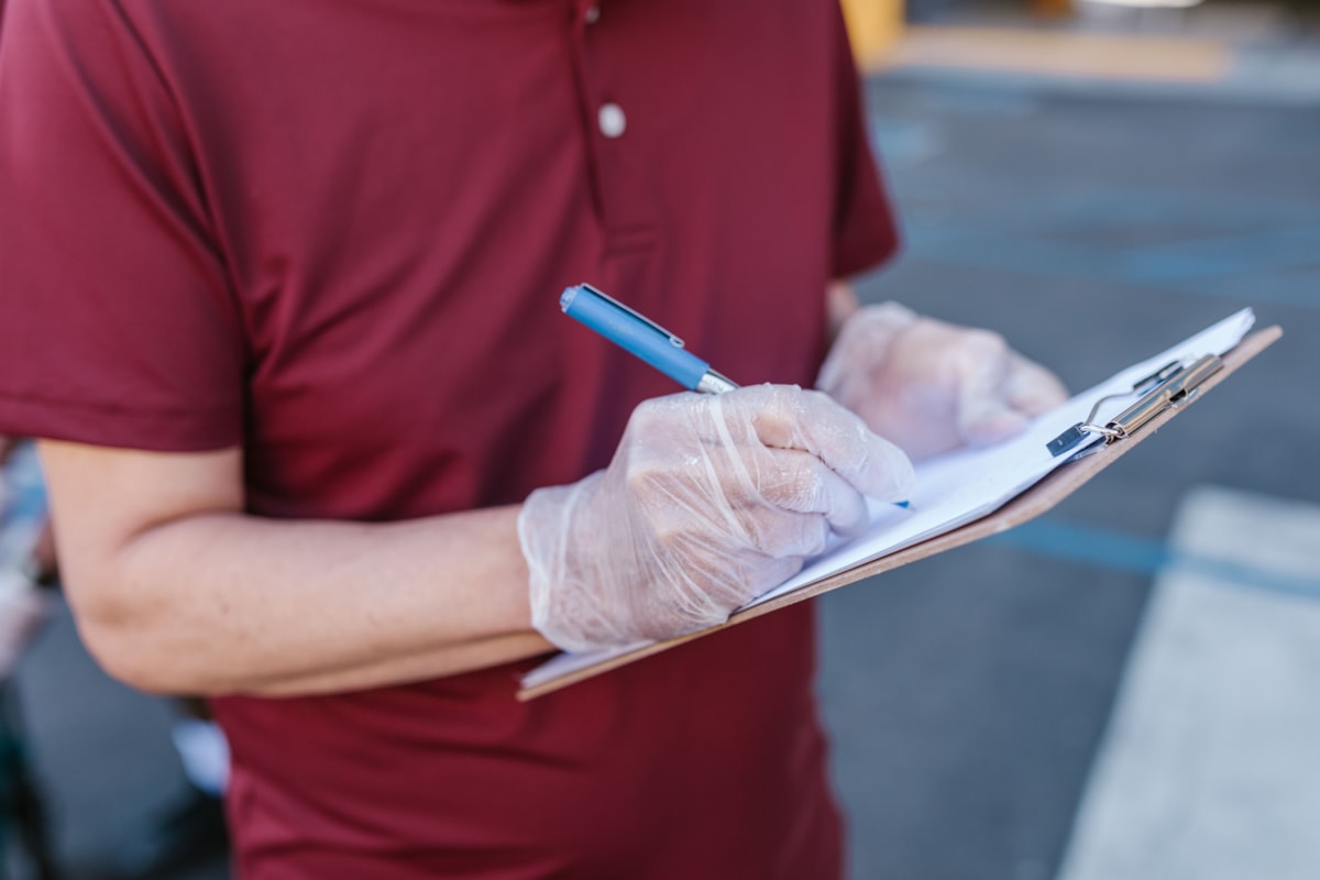 Person in gloves with clipboards