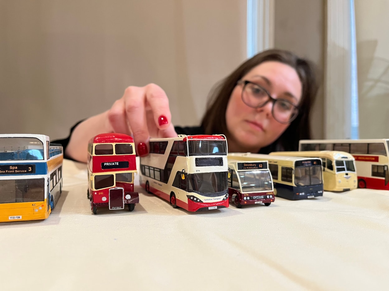 Bus collection: Assistant community curator Sapphia Cunningham-Tate alongside the new display at Leeds City Museum which gives visitors a chance to see a selection of the vast array of replicas created by physicist Dr Gordon Brooke.
The meticulously detailed models each relate to a specific real-life equivalent, complete with service number and with every painstaking detail reproduced using card, packaging and acetate for the windows.
