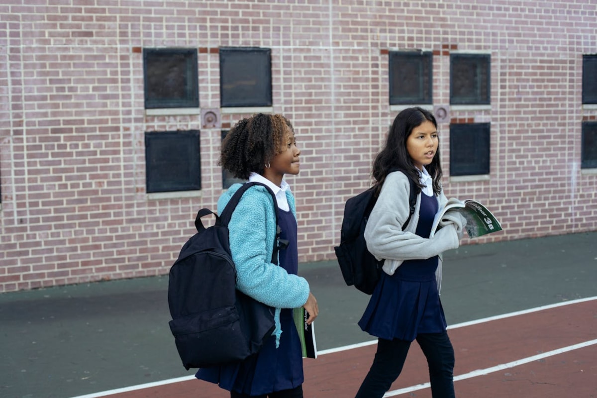 Two girls walking to school