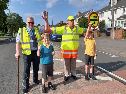 Councillor Damian Corfield, Jake Powell, Chris Darby and Ben Powell on school crossing