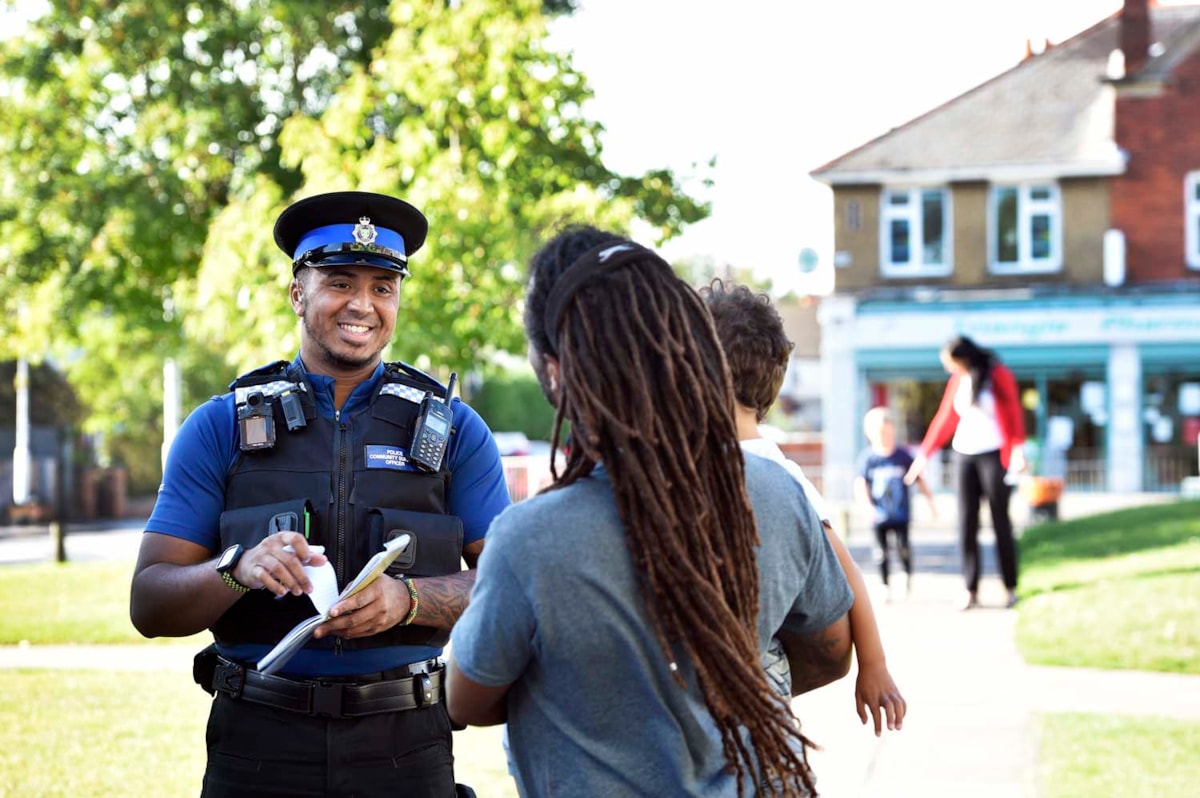 A police officer talking to a member of the public