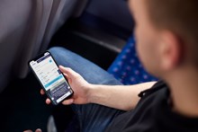 Passenger using Southeastern app on mobile phone: Passenger using Southeastern app on mobile phone