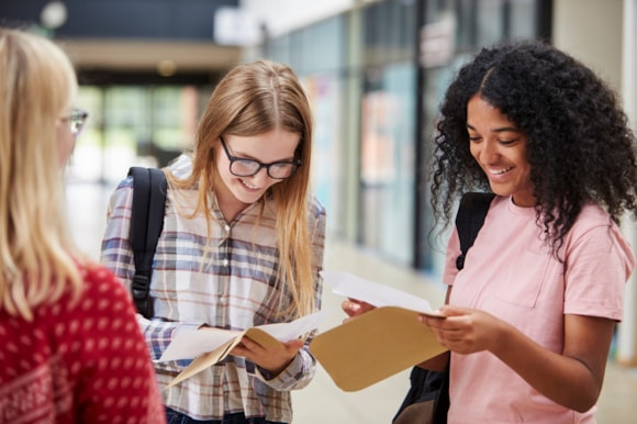 Getting your exam results? Hertfordshire County Council is here to help!: Two girls opening their exam results