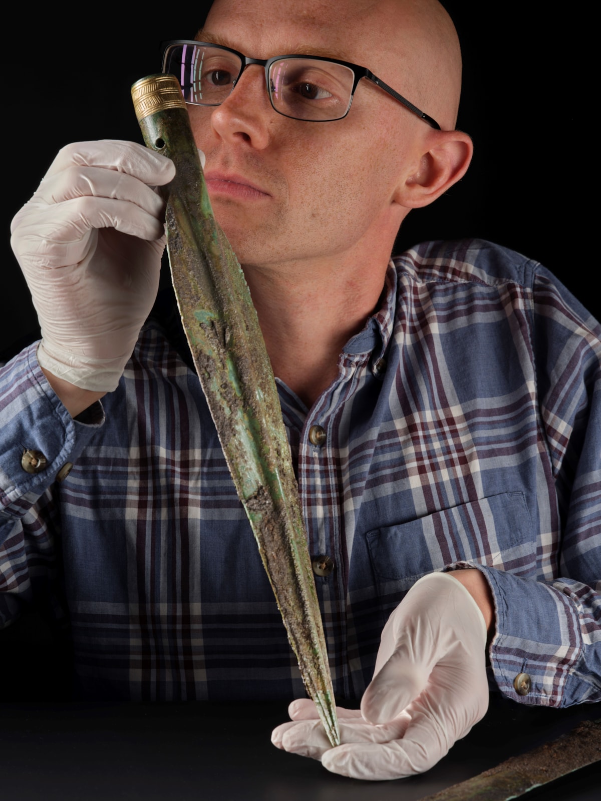 National Museums Scotland curator Dr Matthew Knight examines the Carnoustie Hoard. Photo © National Museums Scotland 3