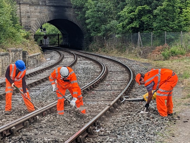 Ballast being shovelled into place around new sleepers at East Lancashire Railway: Ballast being shovelled into place around new sleepers at East Lancashire Railway