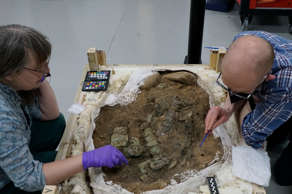 03. Conservator Dr Mary Davis and Curator Dr Matthew Knight excavate the Peebles Hoard. Image Crown Copyright