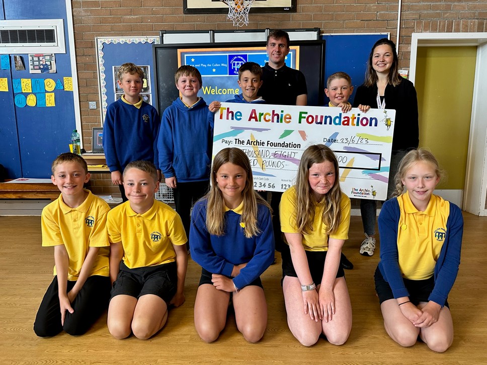 Cullen Primary School present the proceeds of their school marathon to the Archie Foundation