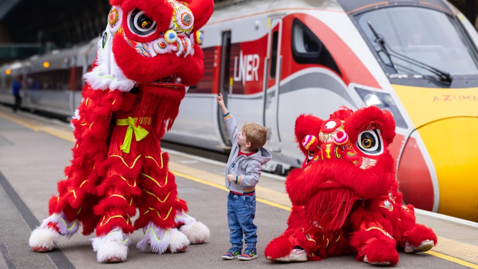 LNER Lions at King's Cross with young customer ahead of Chinese New Year