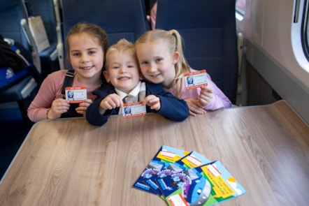 Ivy, 7, Ethan, 4, and Lucy, 7, with their TPE tickets and activity books 