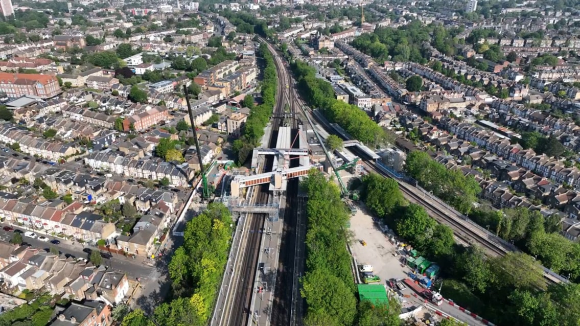 Wider aerial view of Hither Green accessible footbridge being lifted into place