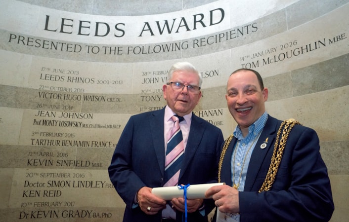 Tom McLoughlin-6: Tom McLoughlin and the Lord Mayor of Leeds, Councillor Dan Cohen, standing in front of the Leeds Award winners' wall in the Civic Hall.