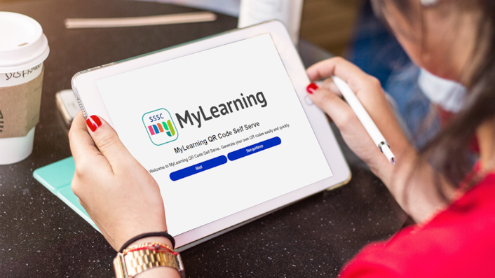 An iPad is showing the SSSC MyLearning QR code self serve