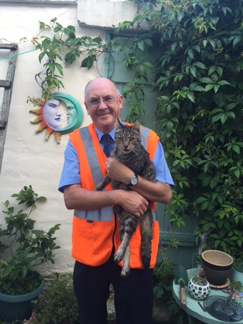 Dave Huntington from Network Rail with Piggy the tabby, the cat he rescued from under the third rail at Bebington station