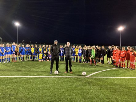 Players from the Secondary School girls football festival in Buckie with Danny Simpson, Active Schools Co-ordinator for Buckie ASG, and Martin Noble, from Doe Sports, contractors who installed the pitch.