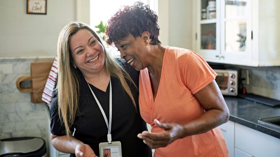 female social care worker assisting other female