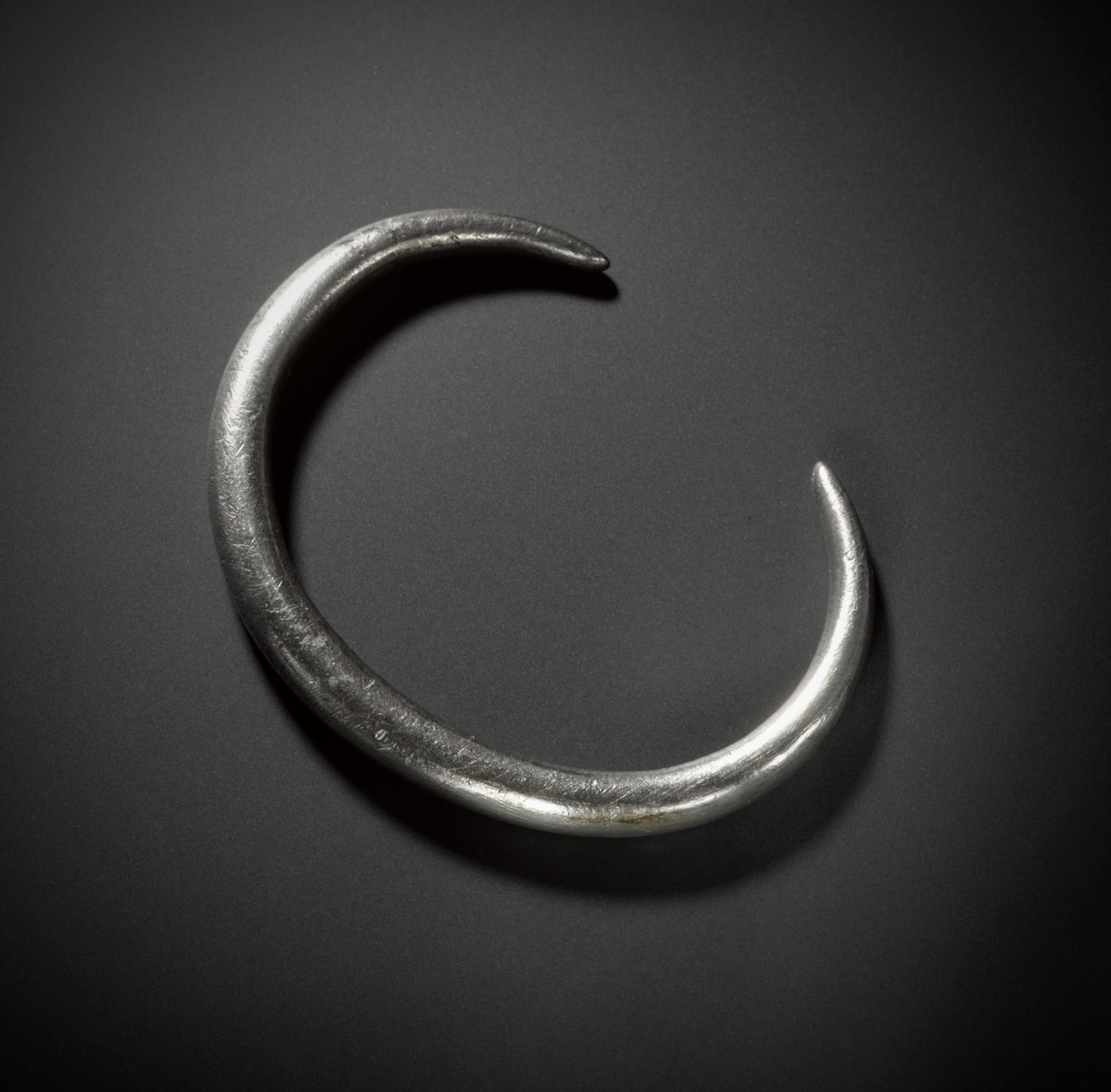 A silver arm ring from the Burray Hoard. Image © National Museums Scotland 2