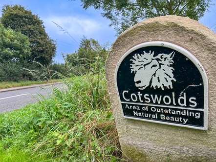 Image shows the Cotswolds Area of Outstanding Natural Beauty Waystone in the Cotswold District.