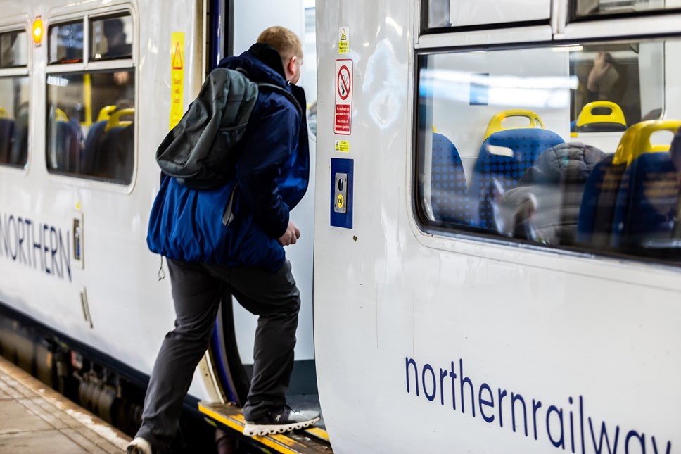 Image shows customer boarding a train