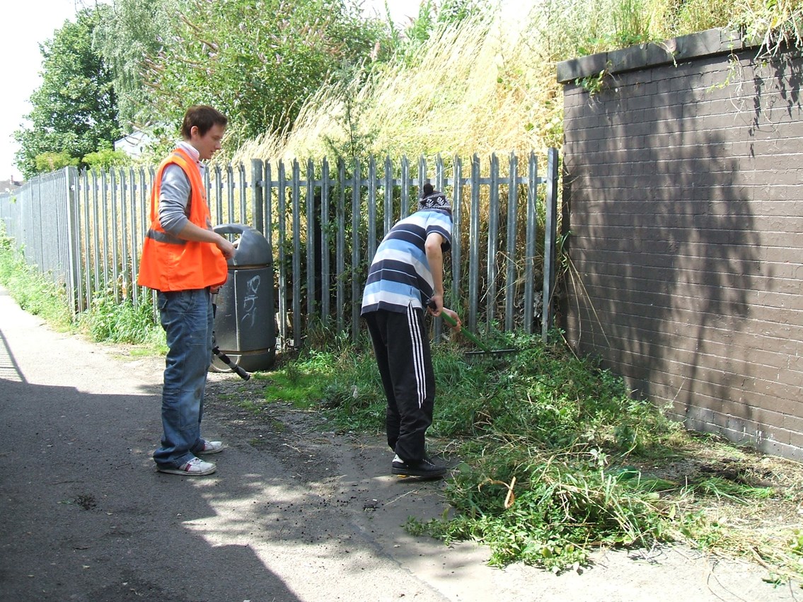 Young offender clearing vegetation at Grantham Station: Young offender clearing vegetation at Grantham Station