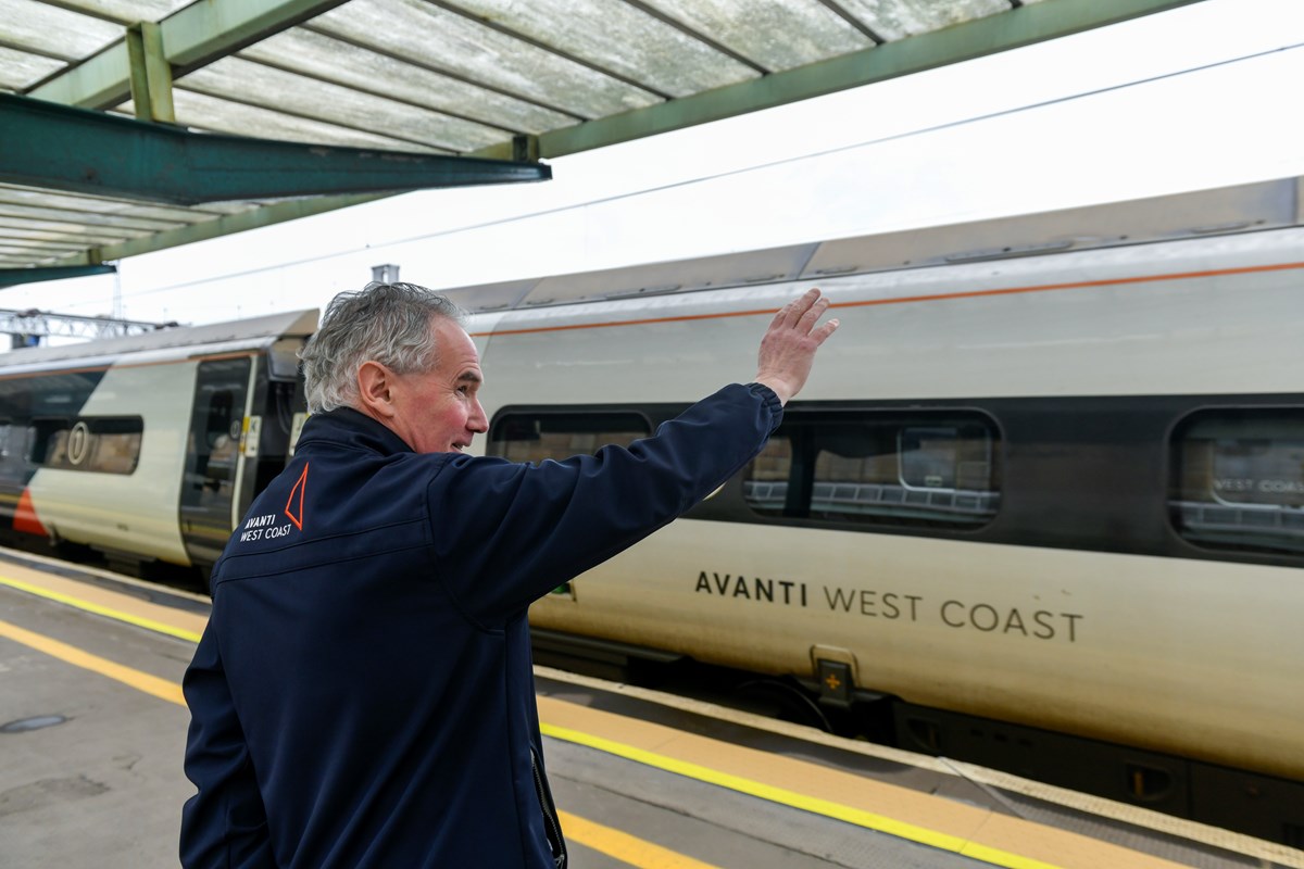 Avanti West Coast Team Leader, Tommy Michalek, waves off Pendolino train at Carlisle station