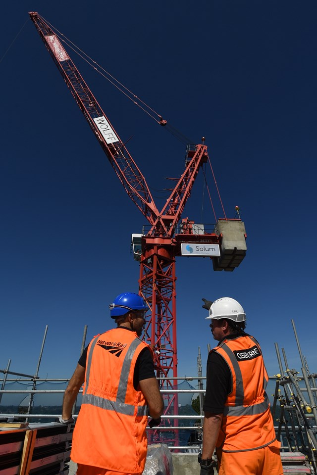 Engineers with crane - portrait