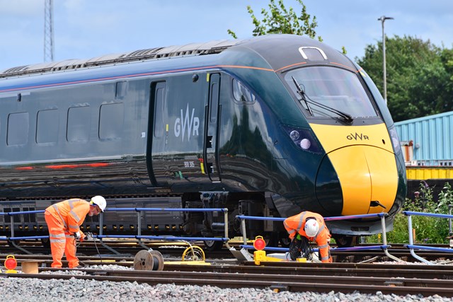 Passengers urged to check before travelling this Easter as essential engineering work takes place in Reading: Engineers on track with GWR train passing by