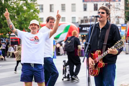 Oasiz performing on King's Cross Square after LNER 'She's Electric' arrival