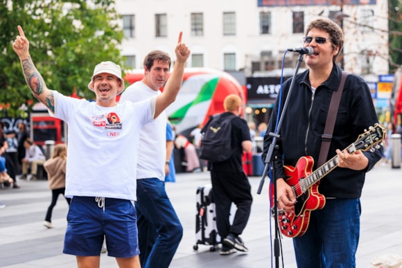 Oasiz performing on King's Cross Square after LNER 'She's Electric' arrival