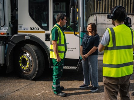 Shirley Rodrigues speaks with a member of staff at the Waste and Recycling Centre, in front of an electric waste collection vehicle