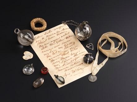 Group of charms used to cure ailments, including a written charm for toothache. Image © National Museums Scotland